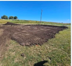 Cleared and graded garage site before construction