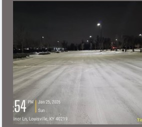 Plowed commercial parking lot at night