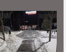 Shoveled sidewalk leading to a storefront